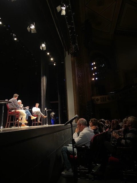 Eddie Lucas, Captain Lee Rosbach, and Colin Macy-O'Toole talk on stage in front of an audience