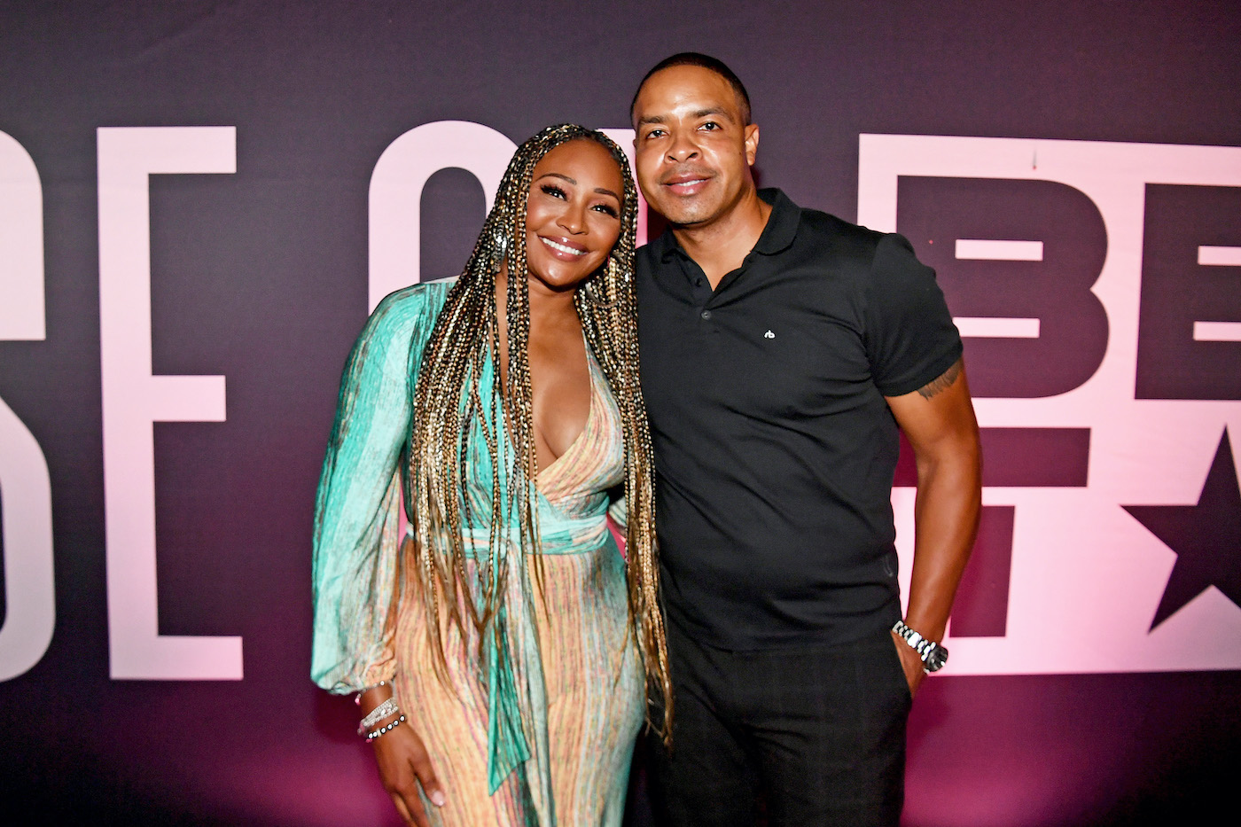 Cynthia Bailey and Mike Hill pose for a photo during a red carpet event.