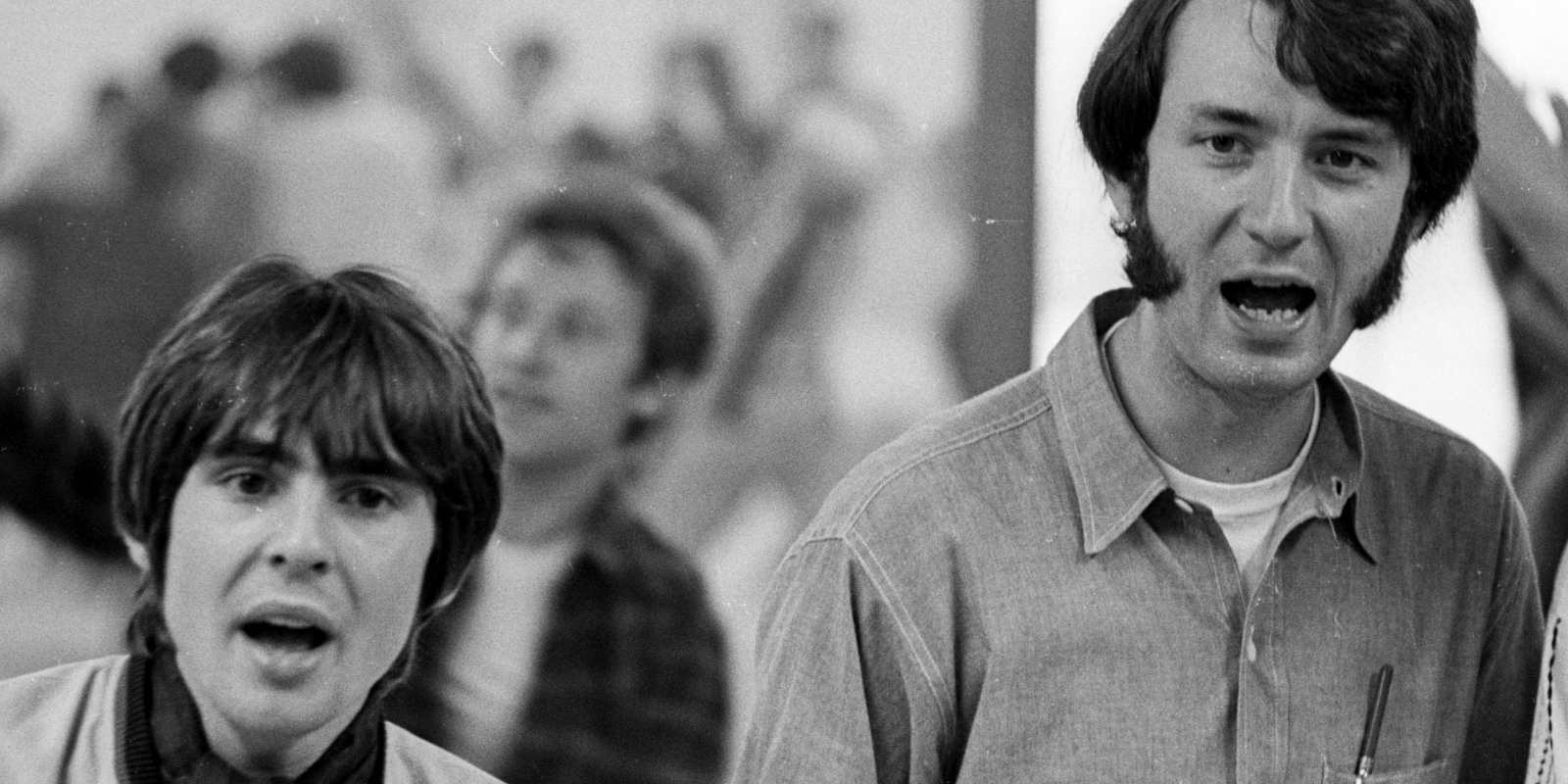 Davy Jones and Mike Nesmith photographed together in a black and white image.