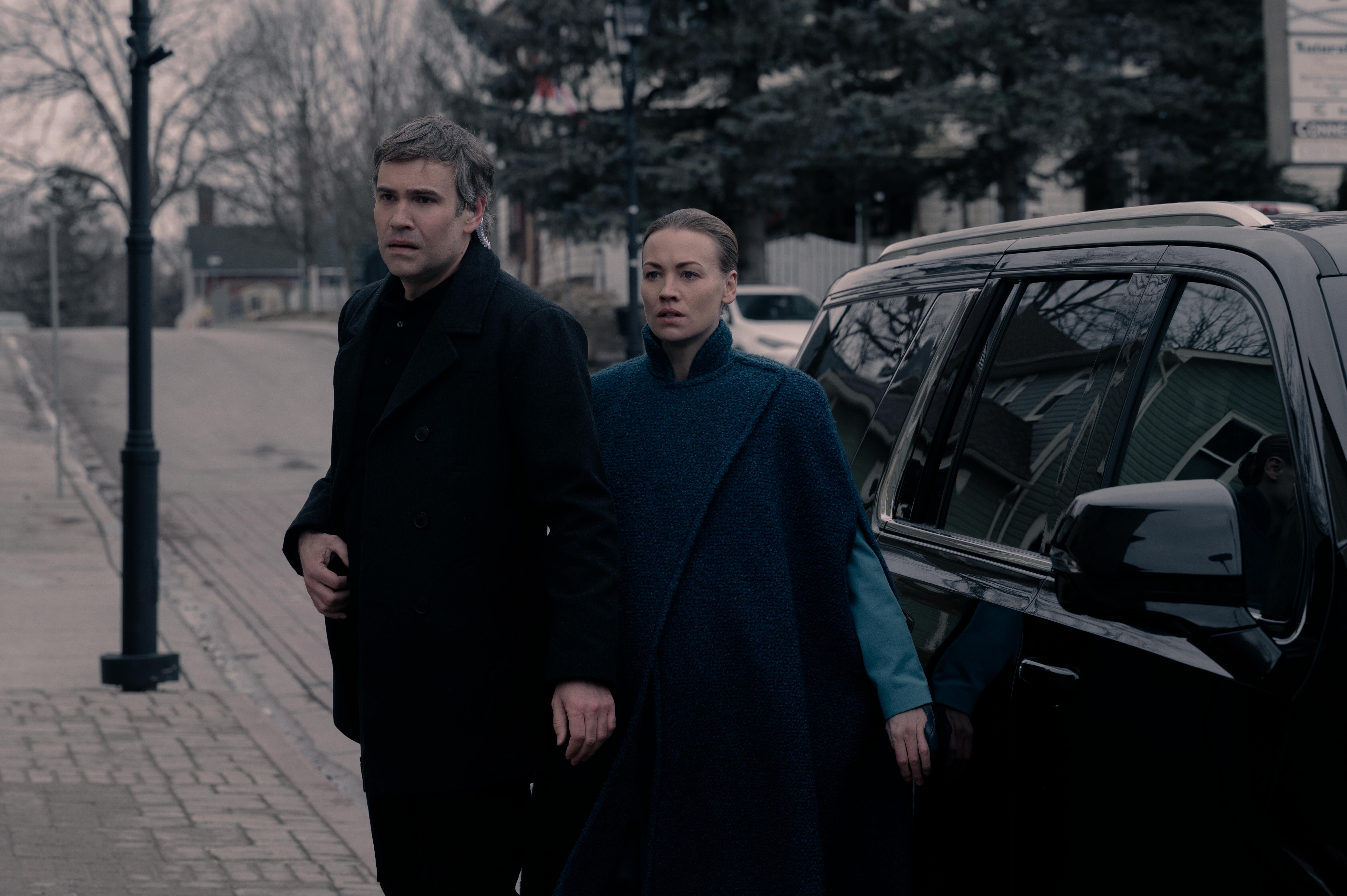 Ezra (Rossif Sutherland), who gets shot by Serena (Yvonne Strahovski) in 'The Handmaid's Tale' Season 5 Episode 6, stand outside of a car in shock.