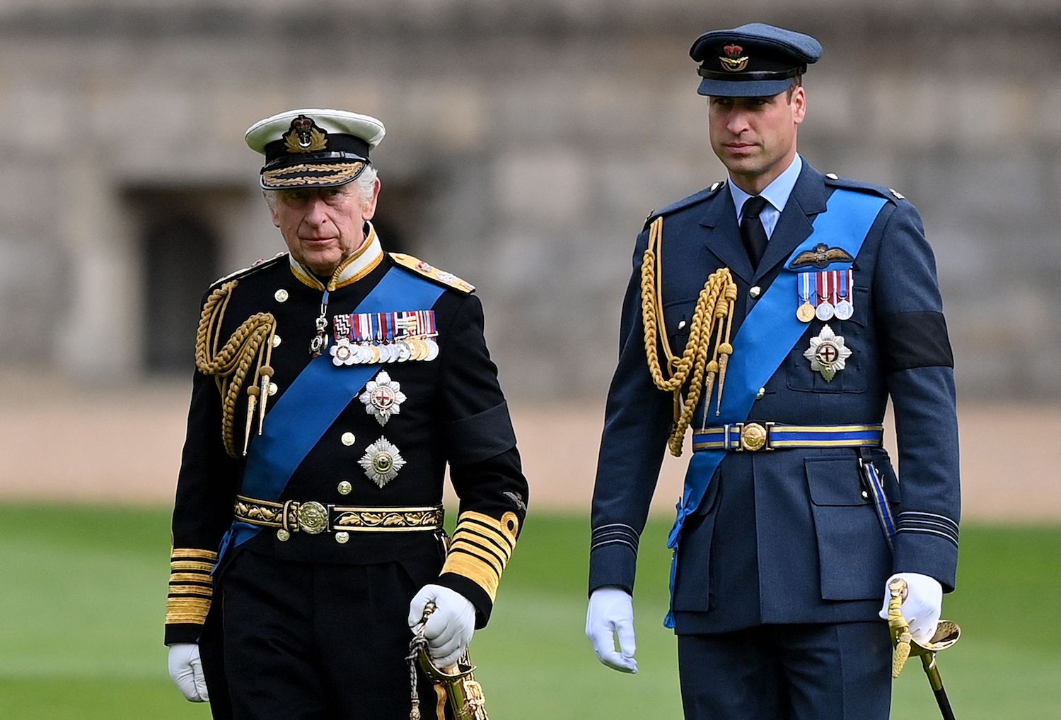 King Charles and Prince William stand together in uniform at the committal service for Queen Elizabeth