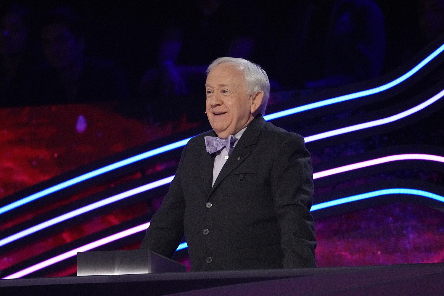 Guest panelist Leslie Jordan stands up and smiles on The Masked Singer Season 7