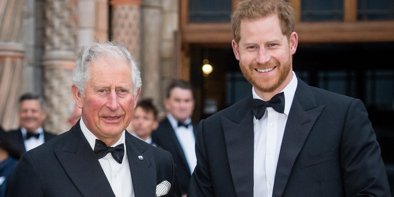 King Charles III and Prince Harry dressed in tuxedos.
