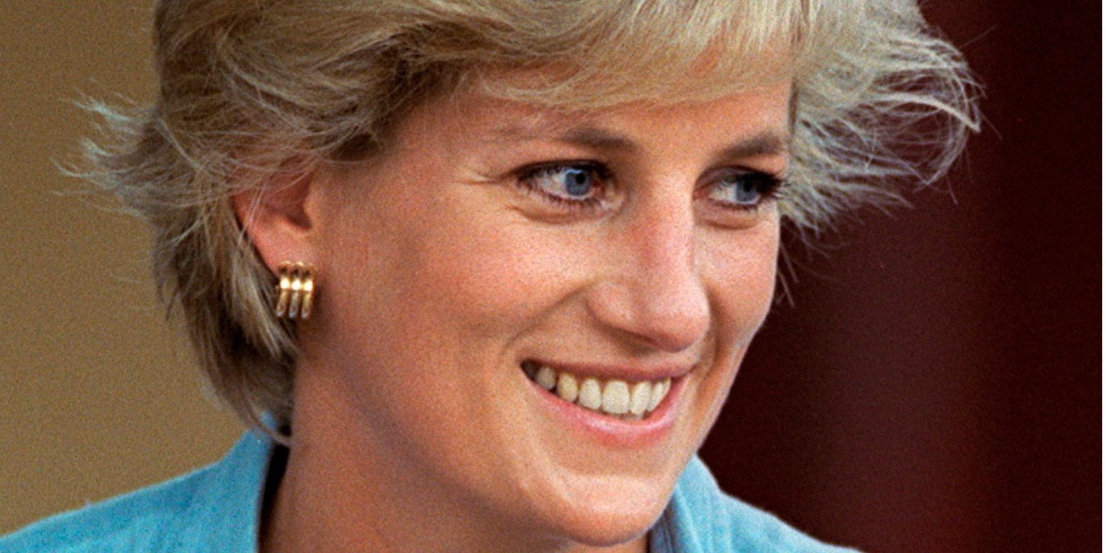 Princess Diana smiles for the camera in a close up photograph.