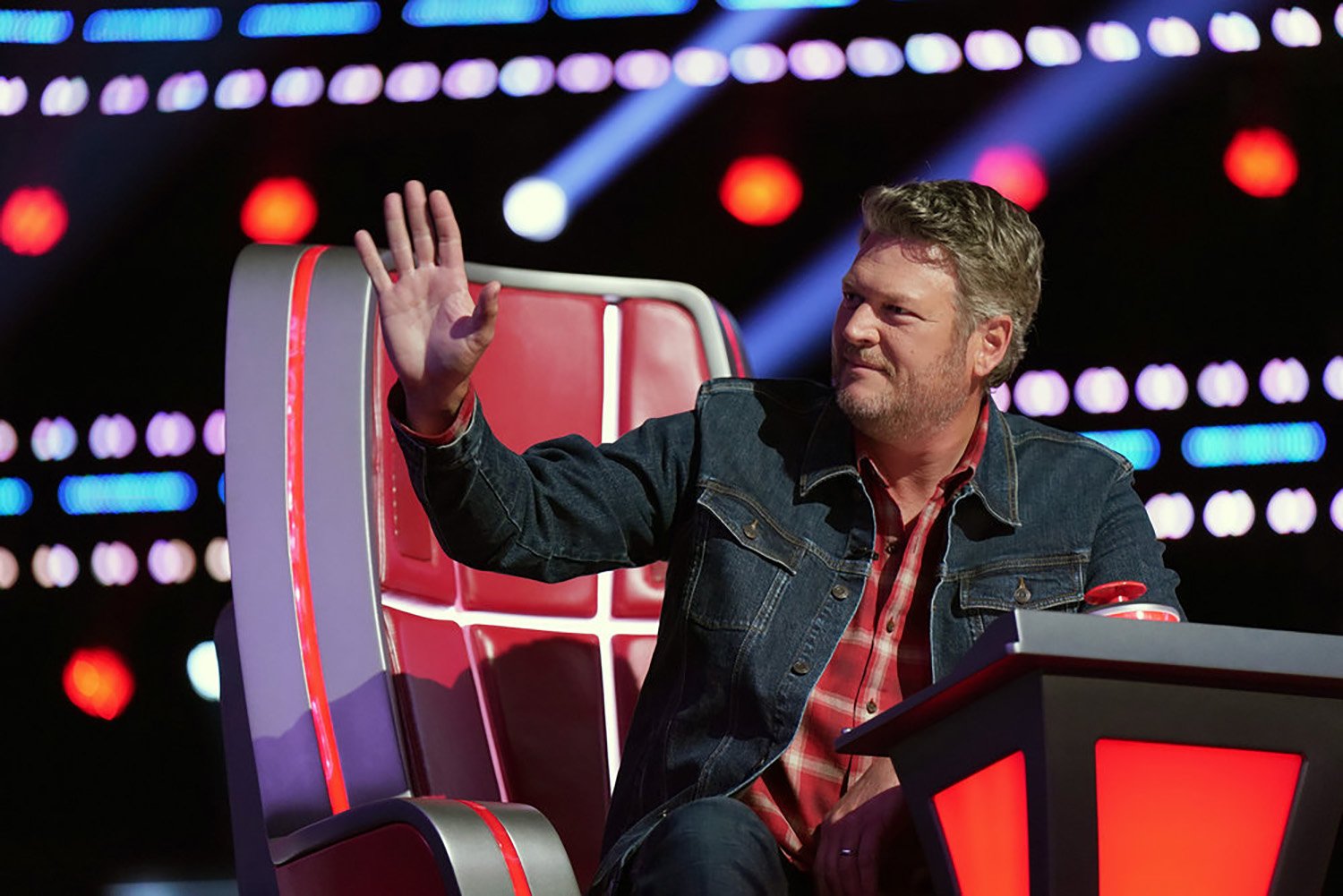 Blake Shelton waves from his chair on The Voice Season 22 after he announces he's leaving