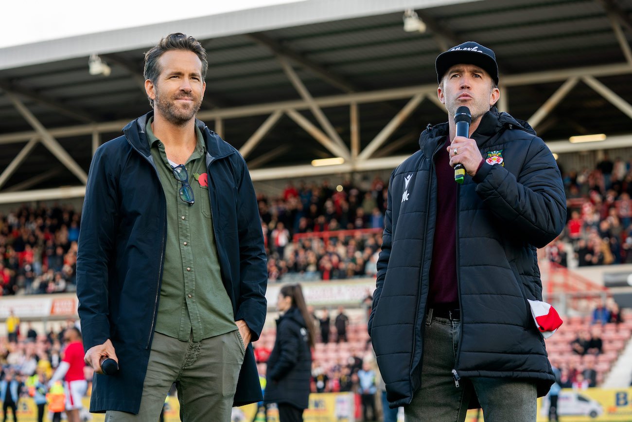Ryan Reynolds and Rob McElhenney, who confirmed season 2 of 'Welcome to Wrexham,' on the pitch in the first season of the Hulu series