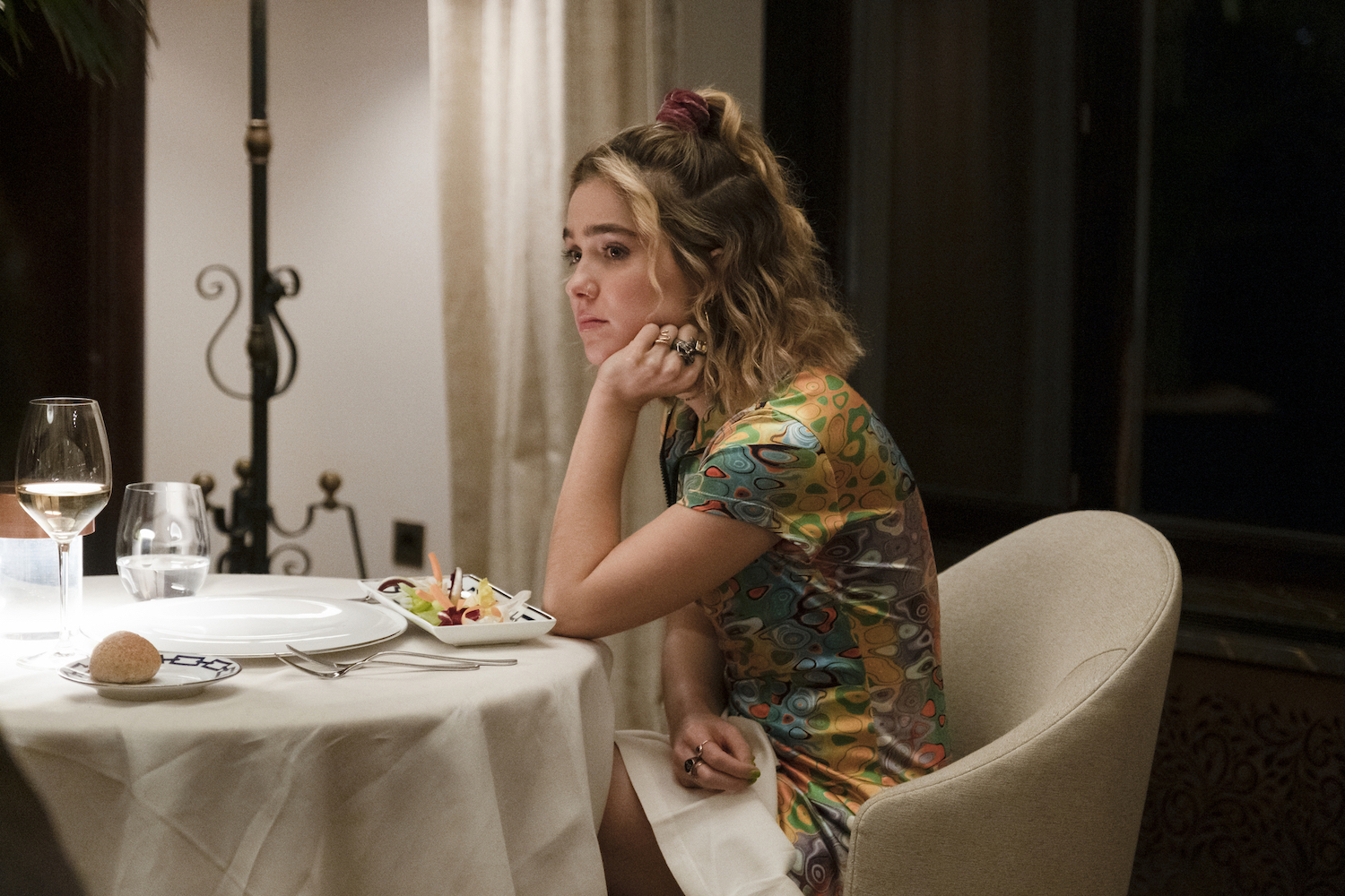 'The White Lotus' stars Haley Lu Richardson seen sitting a restaurant table alone in the season 2 premiere.