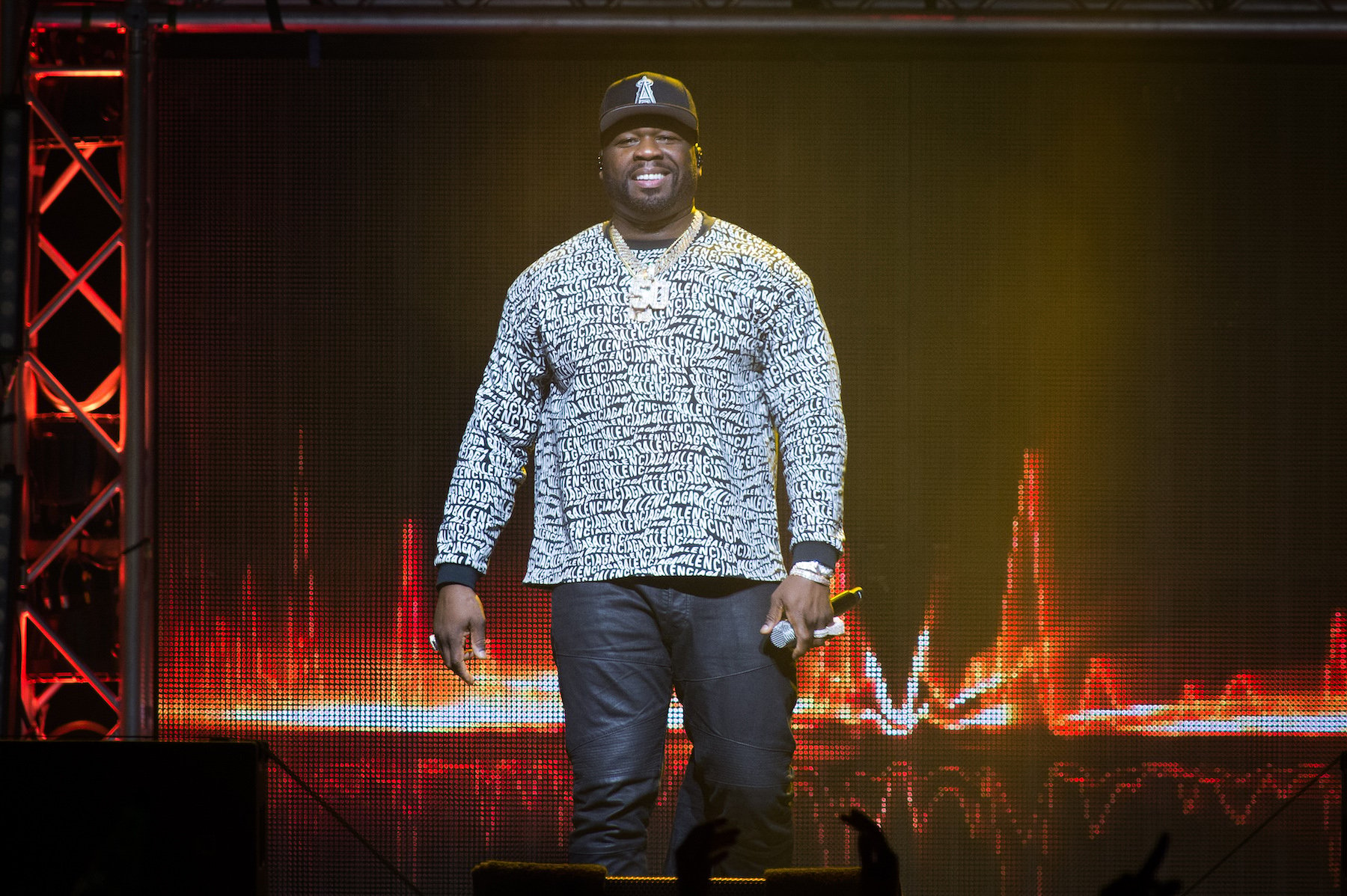 50 Cent, who has a partnership with the Houston Astros, on stage in a gray sweater