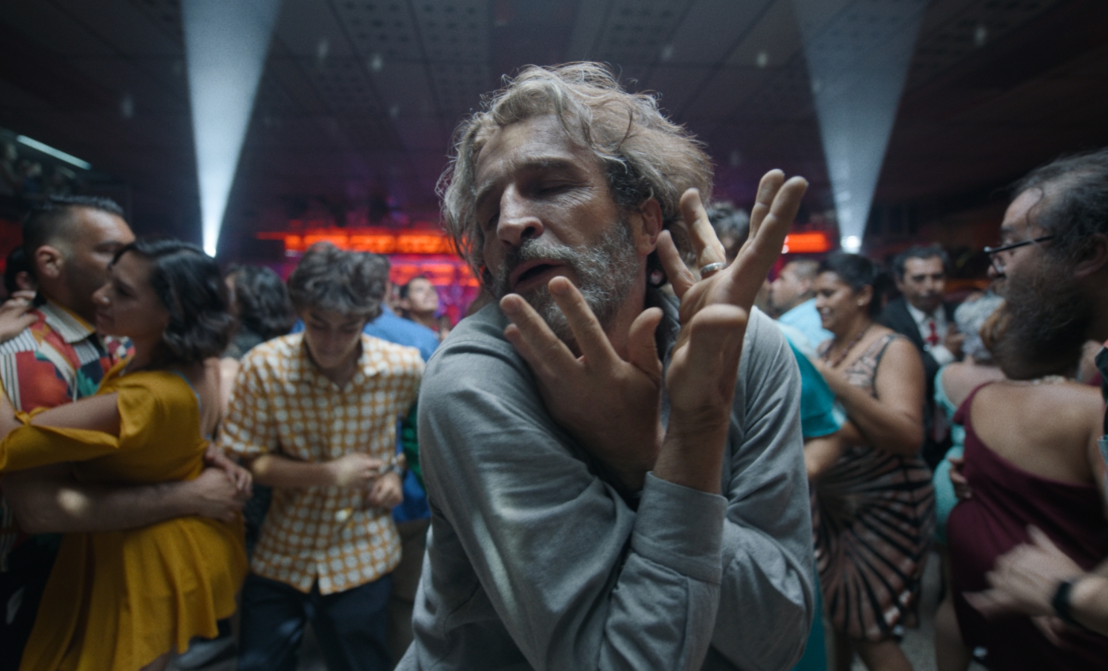 'Bardo' Daniel Giménez Cacho as Silverio Gacho dancing in a crowd with his hands crossed.