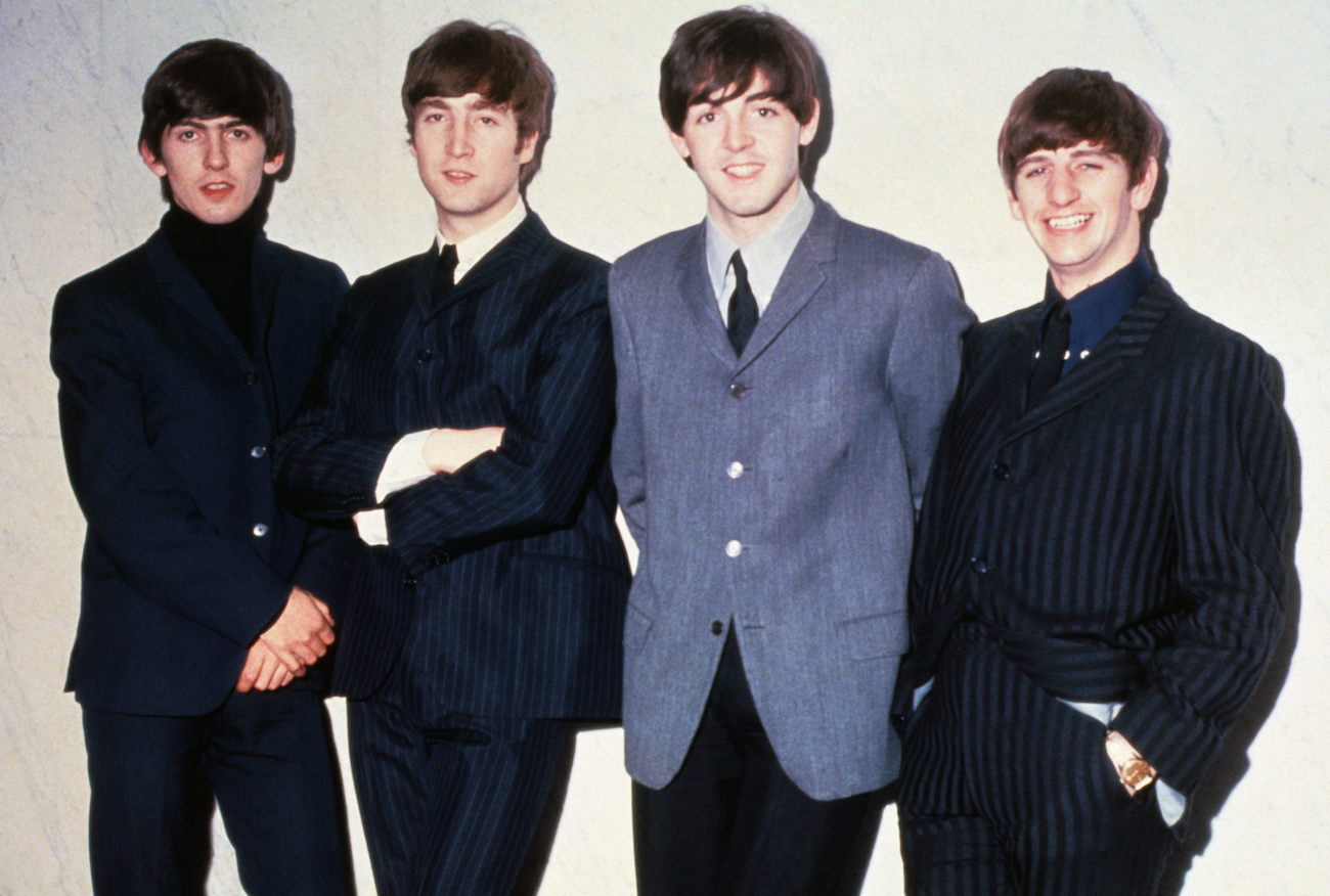 The Beatles posing in suits in 1964.