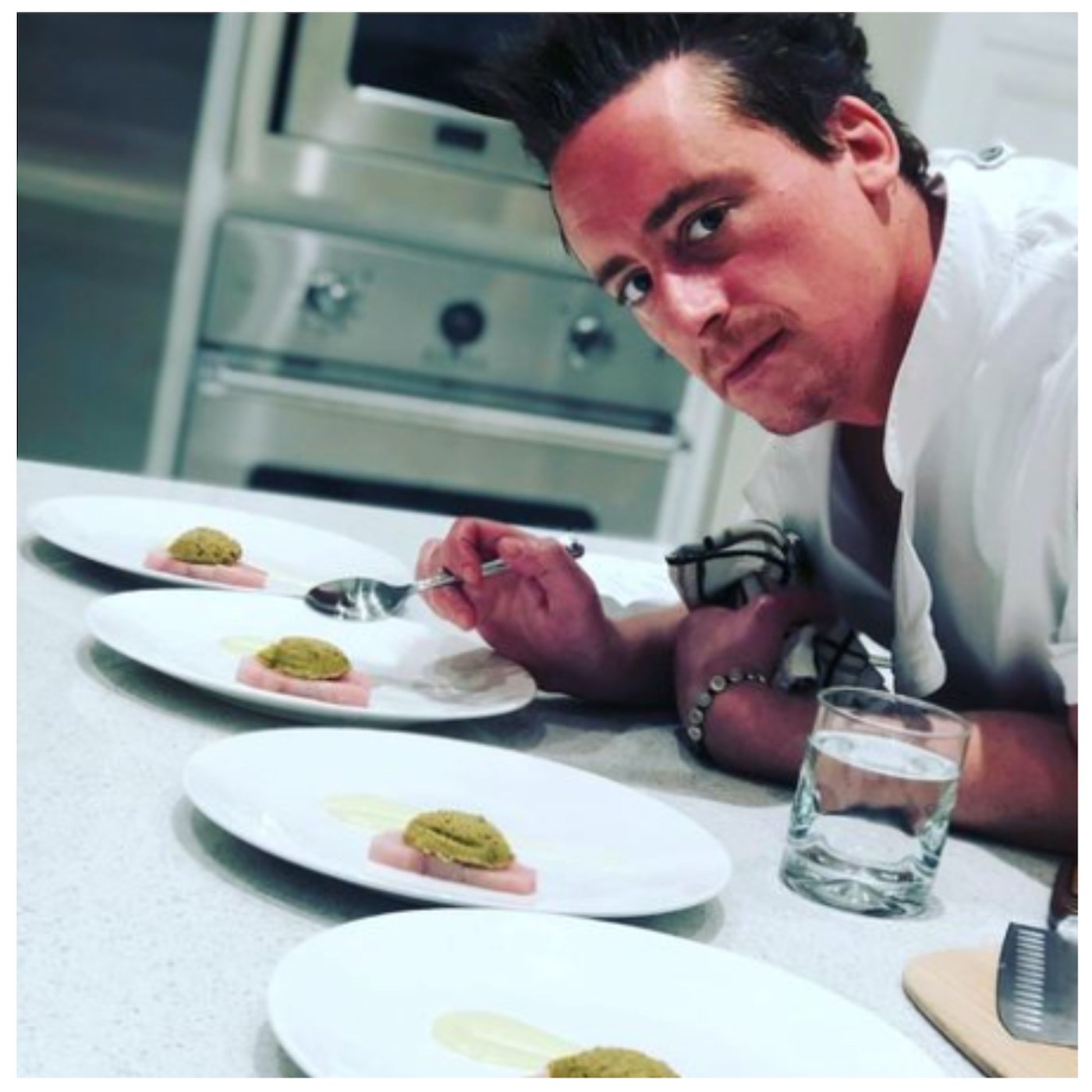 Chef Ben Robinson from 'Below Deck' looks up from plating food 
