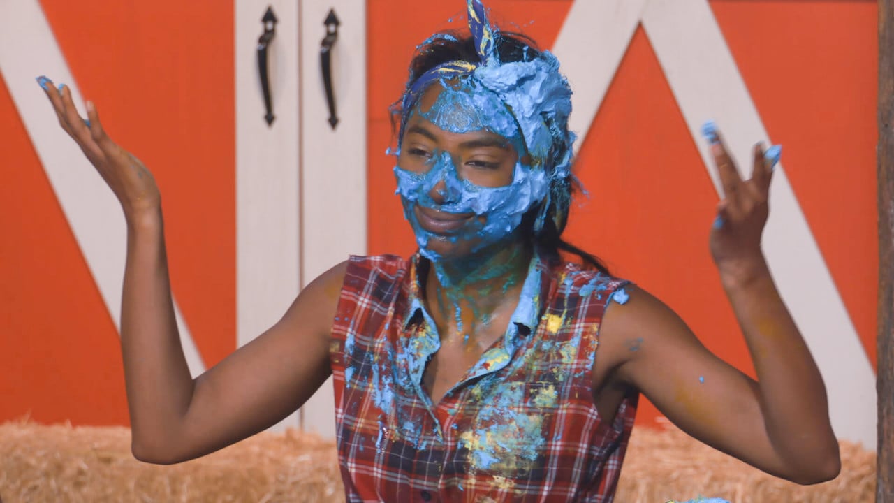 Taylor Hale sits covered in blue frosting on 'Big Brother 24'.