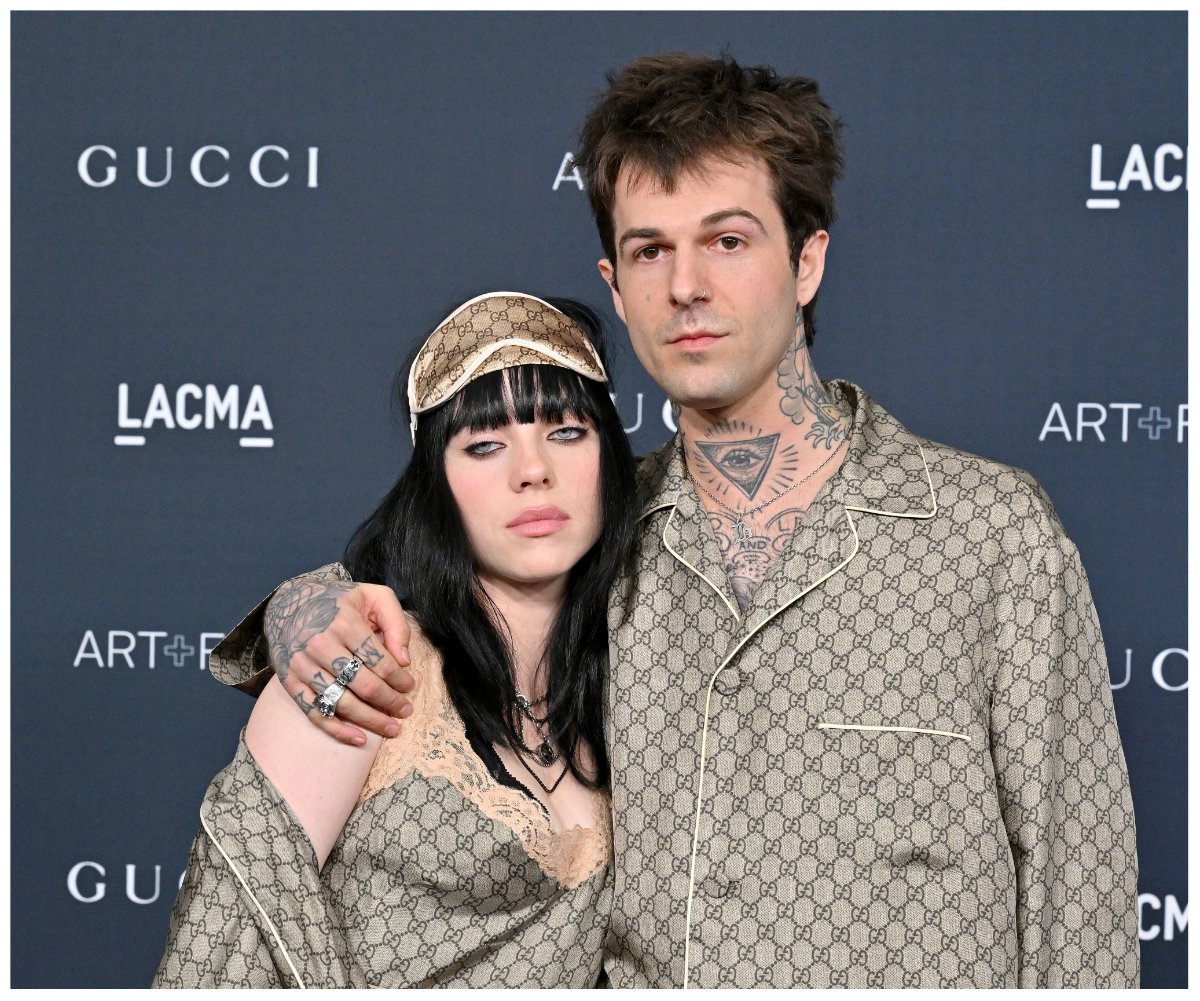 Billie Eilish and her new boyfriend, Jesse Rutherford, pose together on a red carpet in matching outfits.