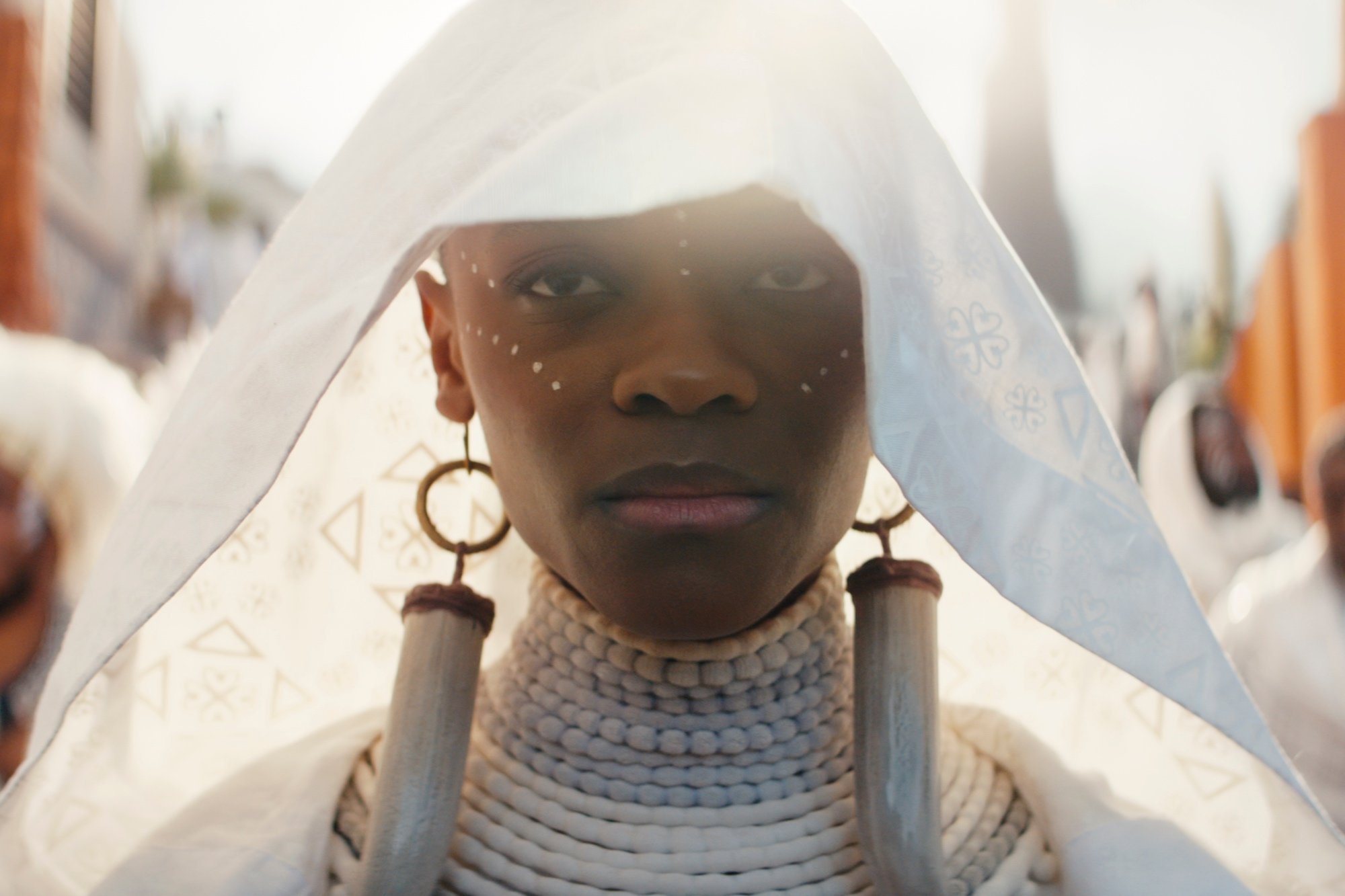 'Black Panther: Wakanda Forever' Letitia Wright as Shuri wearing a white robe and bone earrings
