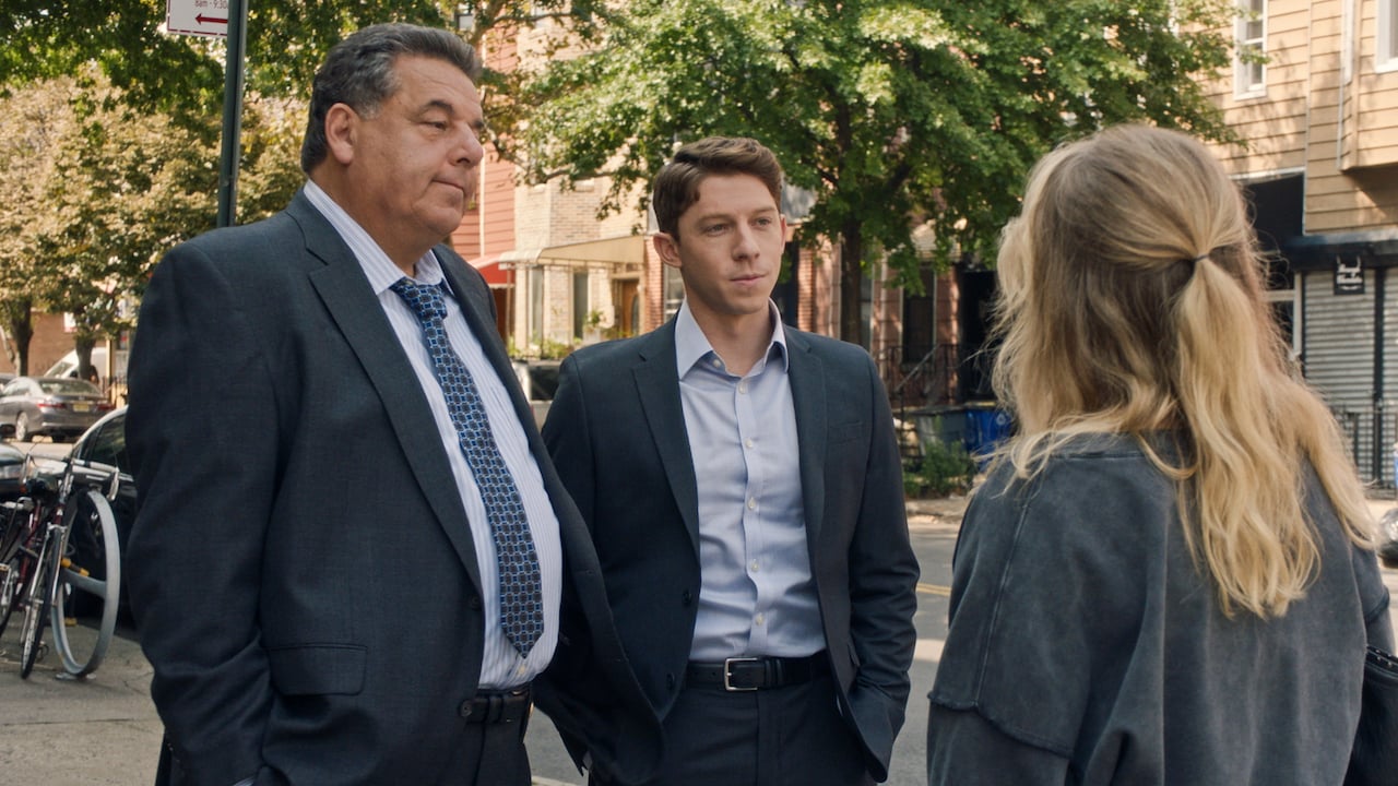 Anthony Abetemarco (Steven Schirripa) and Joe Hill (Will Hochman) stand in suits on the street on 'Blue Bloods'.