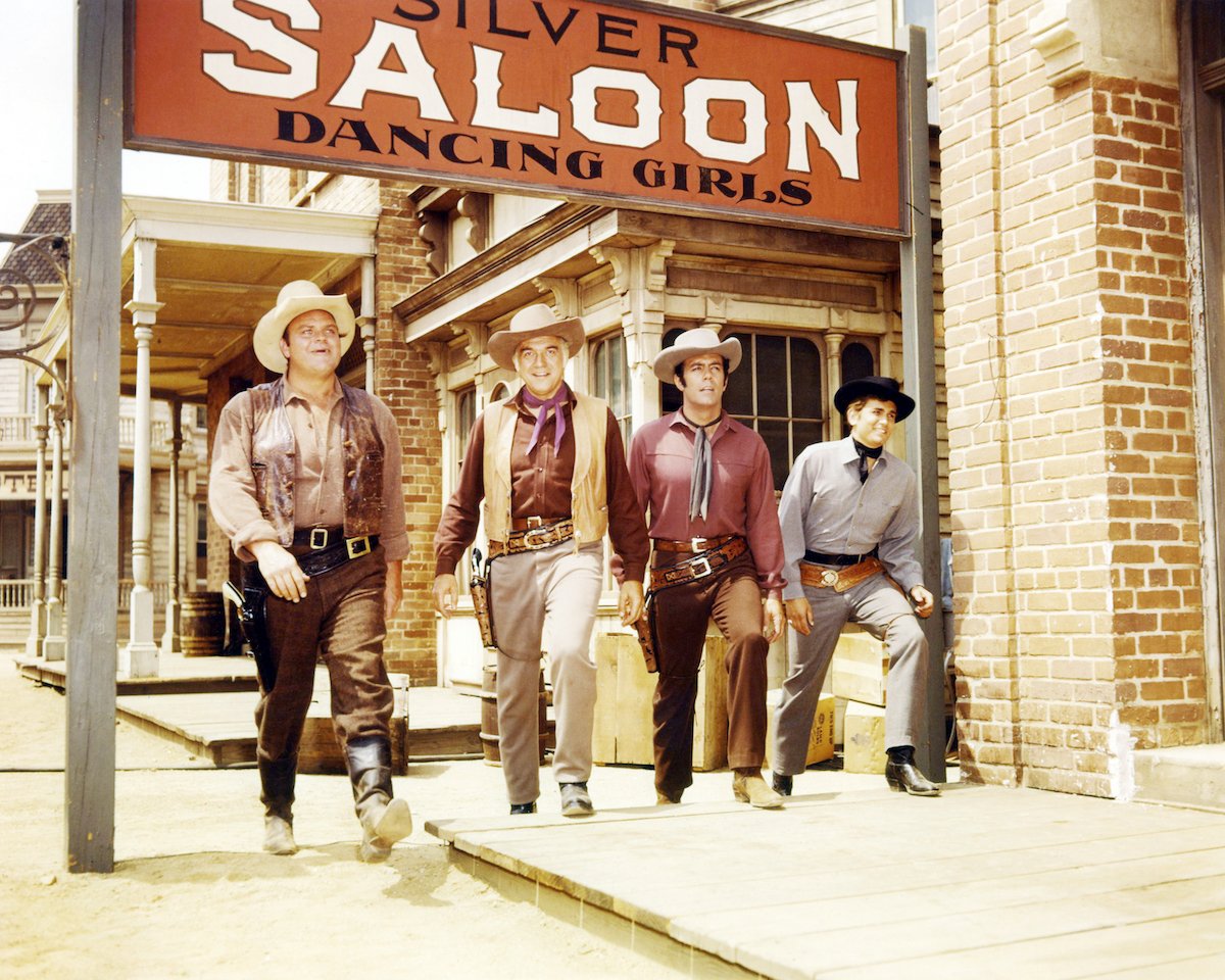 Dan Blocker, Lorne Greene, Pernell Roberts, and Michael Landon in Western clothing walking side by side in 'Bonanza'