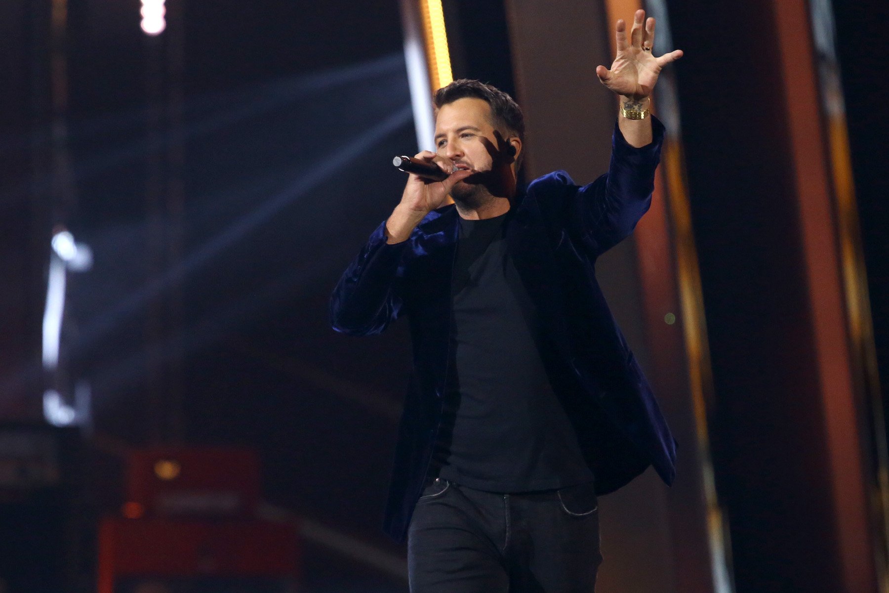 Luke Bryan, CMA winner and 2022 co-host, performing in a black jacket