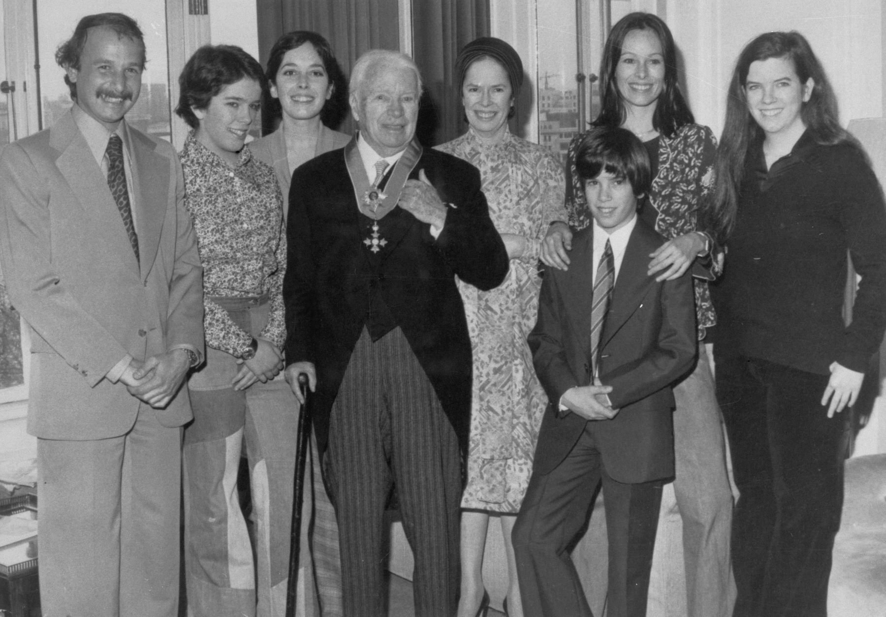 Charlie Chaplin with family at the Savoy Hotel after being knighted by Queen Elizabeth II at Buckingham Palace
