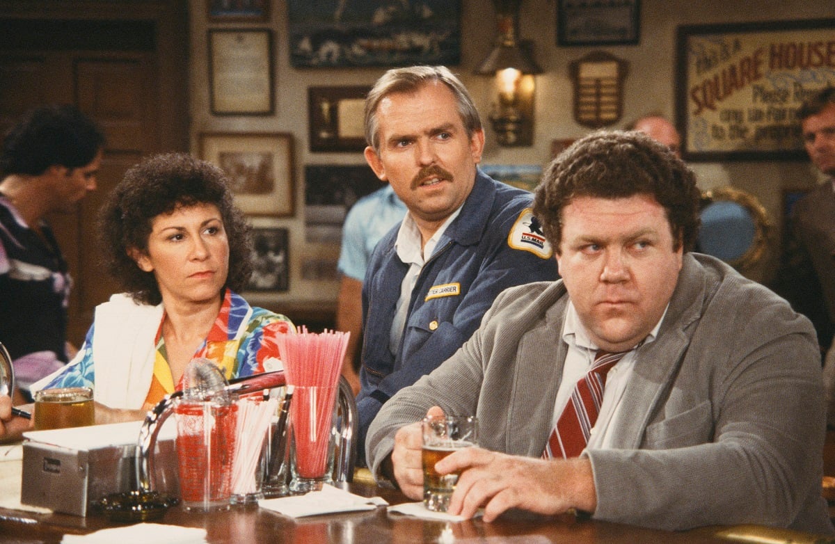 Rhea Perlman as Carla Tortelli, John Ratzenberger as Cliff Clavin, and George Wendt as Norm Peterson in 'Cheers'