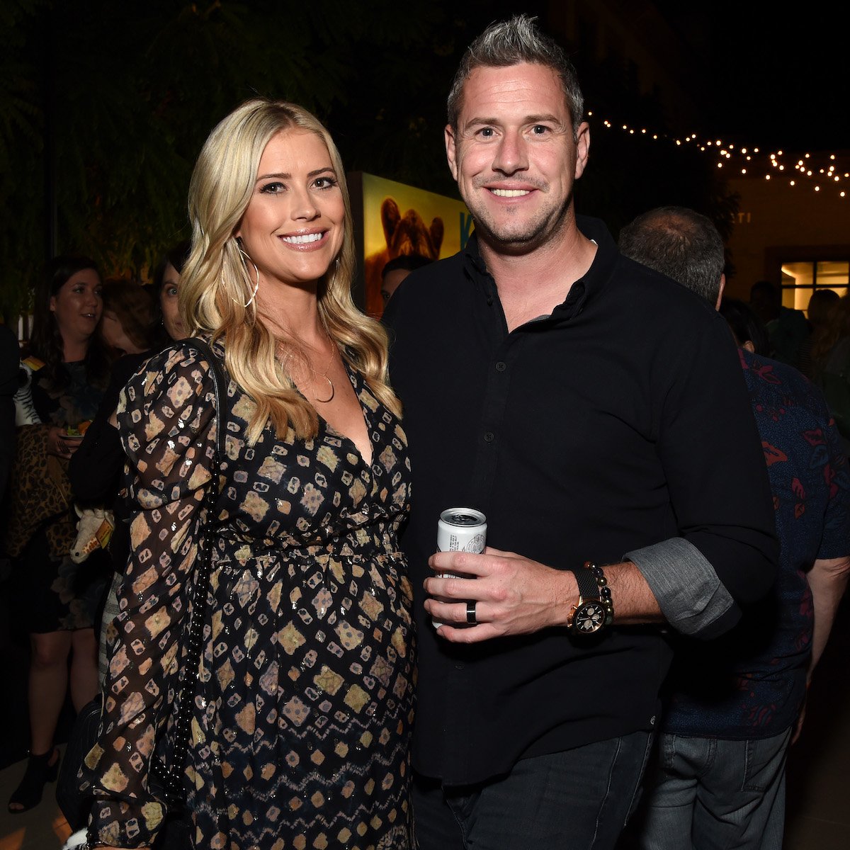 Christina Hall and Ant Anstead, who share one son named Hudson, smile together at an event.