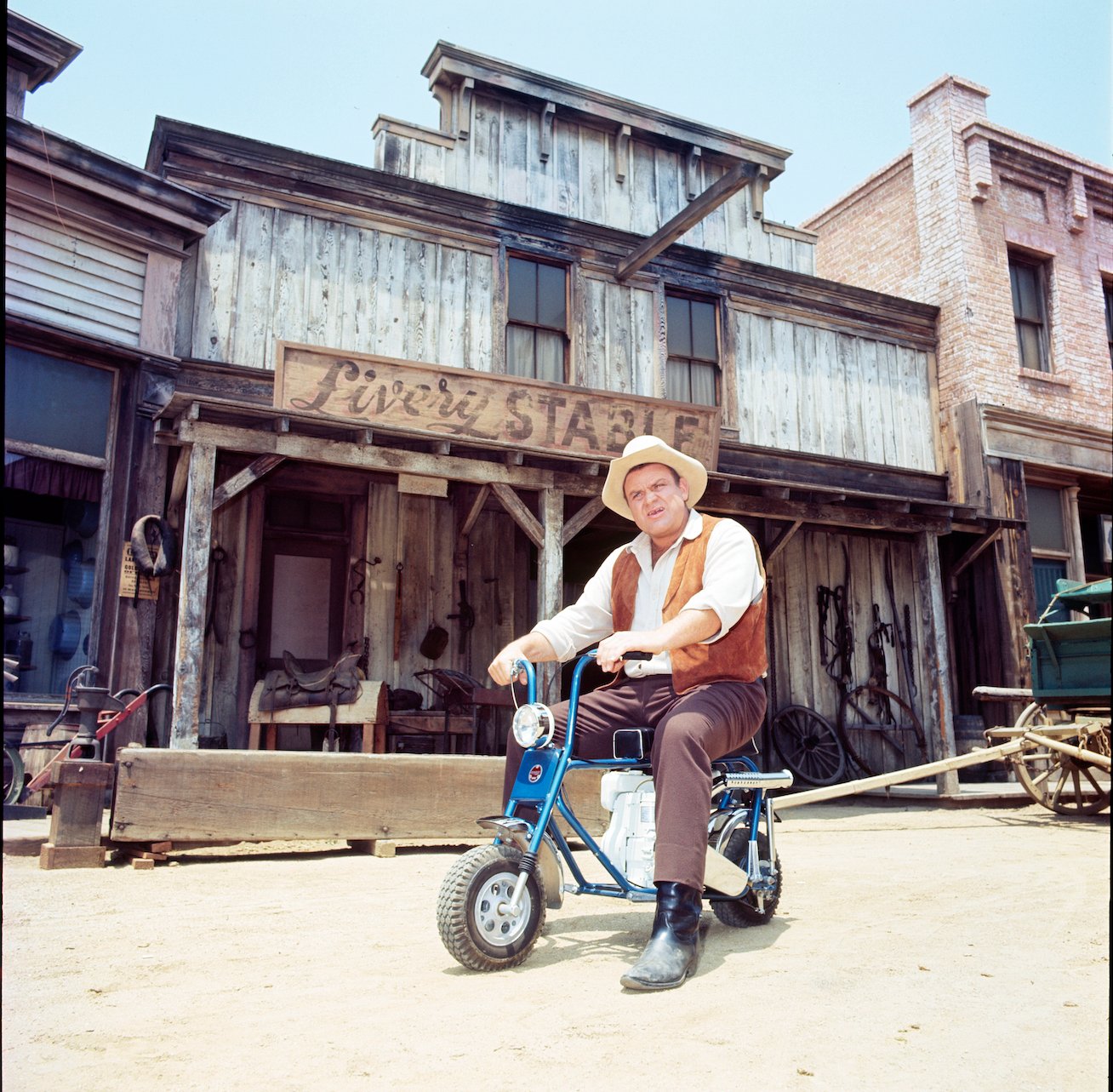 Dan Blocker riding a mini motorcycle in 'Bonanza'