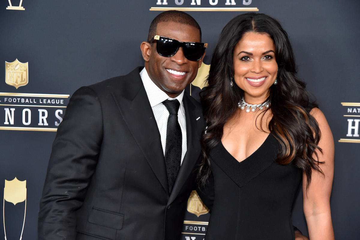 Former NFL player Deion Sanders and Tracey Edmonds smile at the 2018 NFL Honors