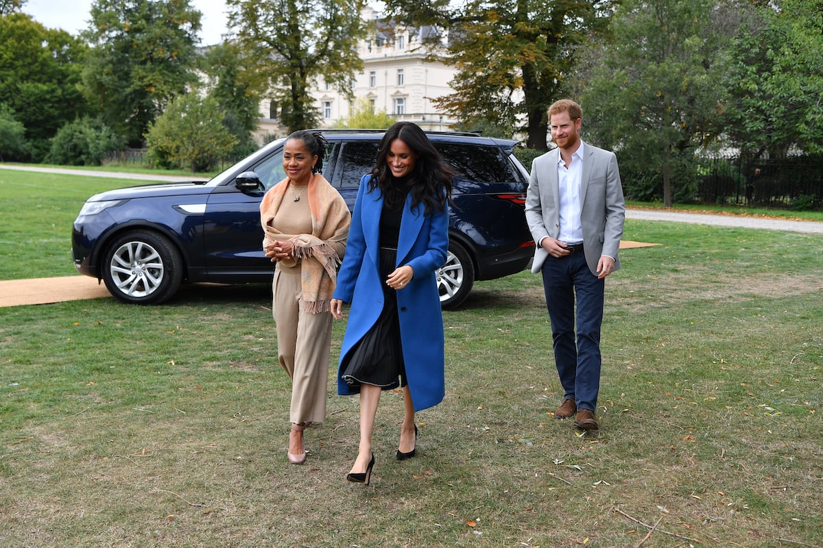 Doria Ragland, who was in mom 'mode' during a surprise appearance on Meghan Markle's Spotify 'Archetypes' podcast Nov. 1 episode, according to body language expert Judi James, walks with Meghan Markle and Prince Harry