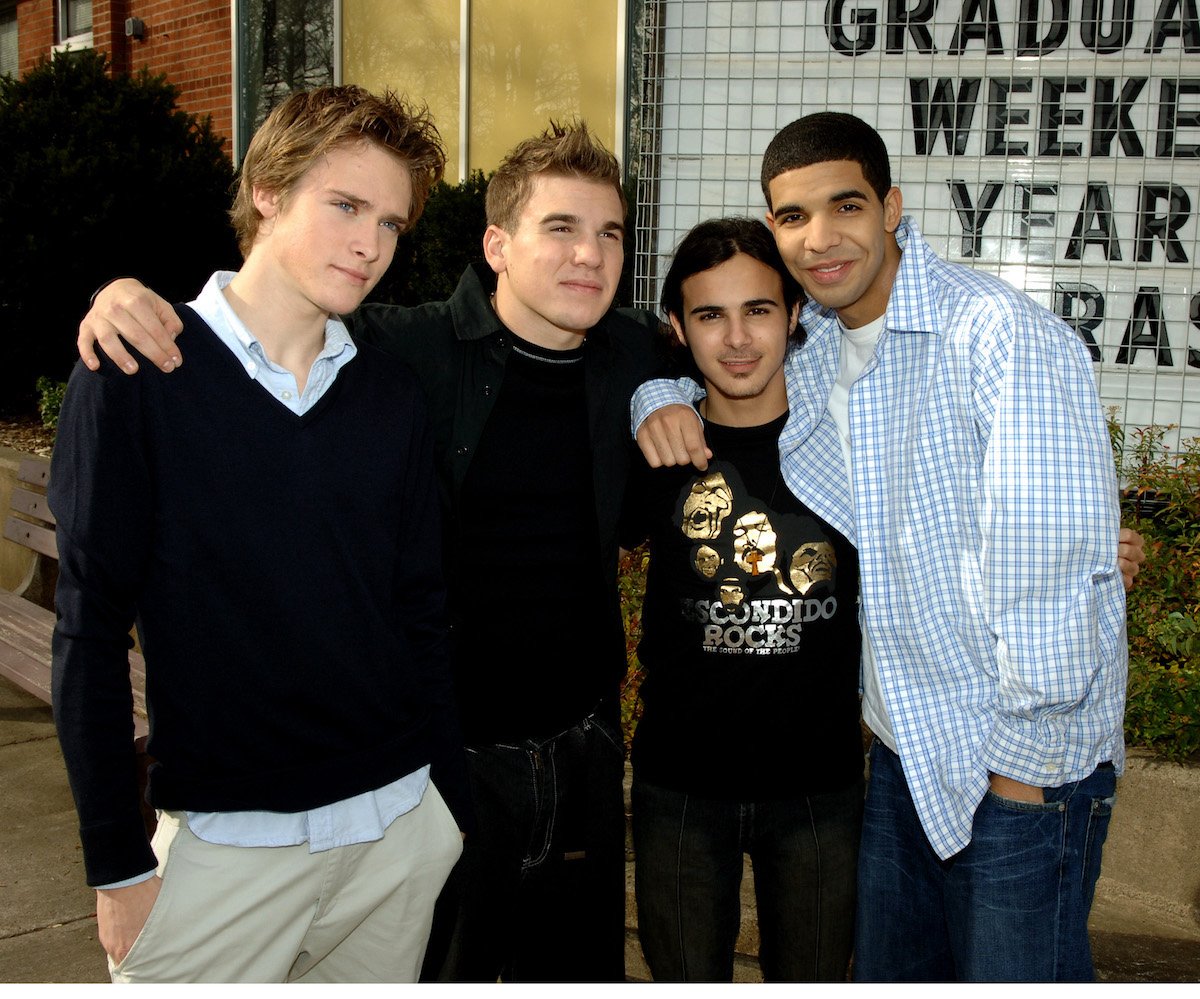 Jamie Johnston, Shane Kippel, Adamo Ruggiero, and Aubrey Graham (Drake) smile together at the Degrassi High School set in Toronto, Canada