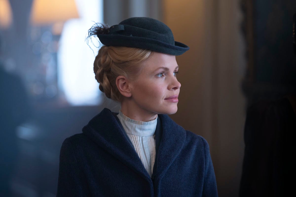 Kate Phillips in profile and wearing a hat in 'Miss Scarlet and The Duke' Season 3
