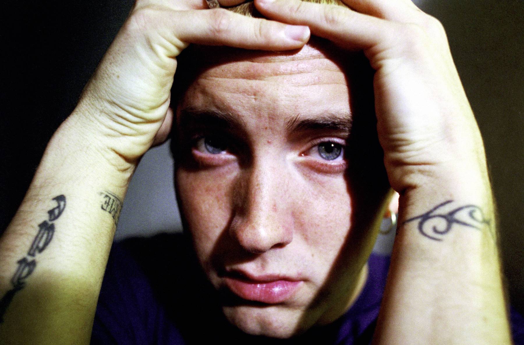 Eminem, who was subject to bullying as a child, posing for a photo
