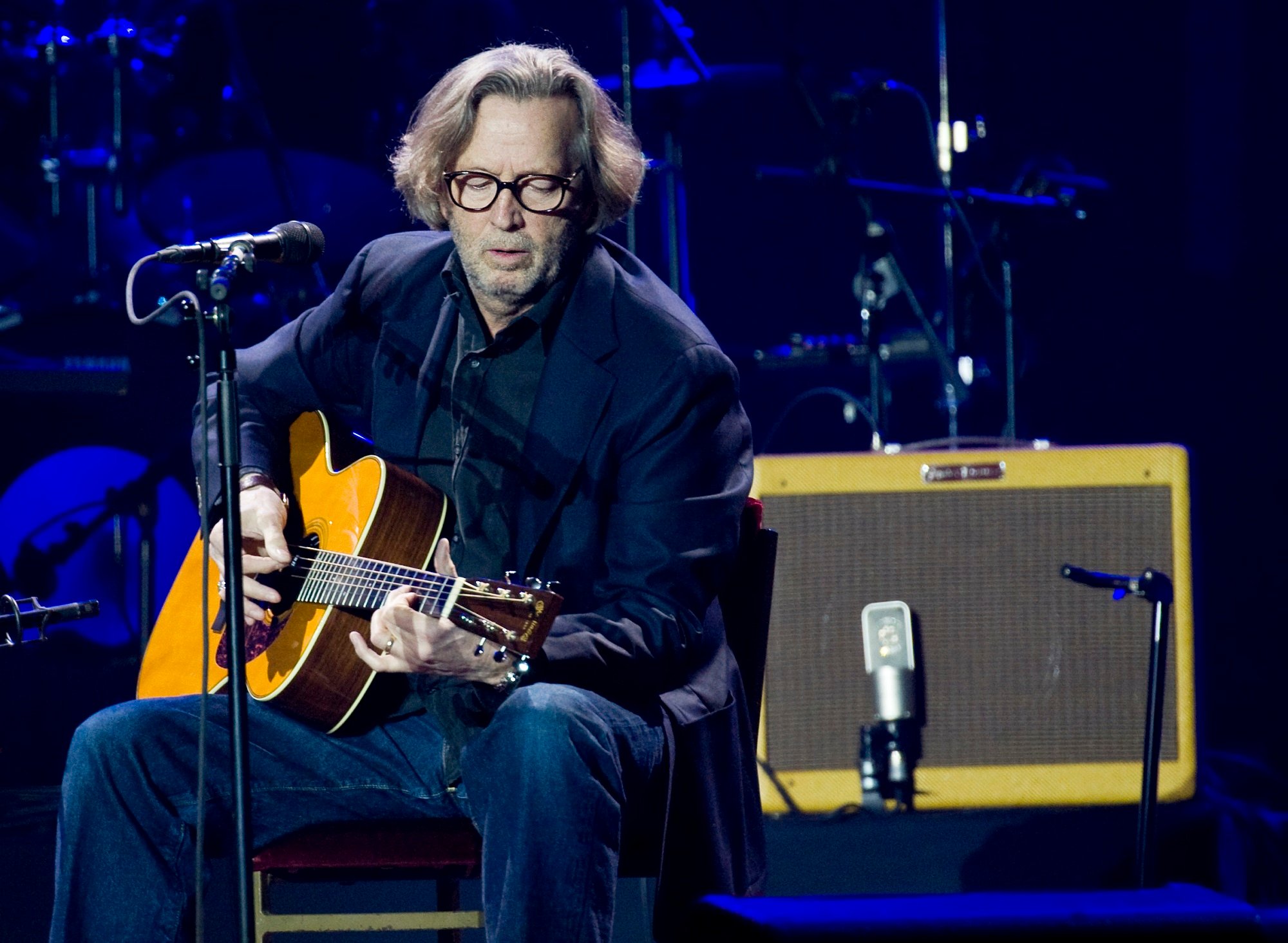 Eric Clapton performs on stage with a Martin 000-28EC acoustic guitar