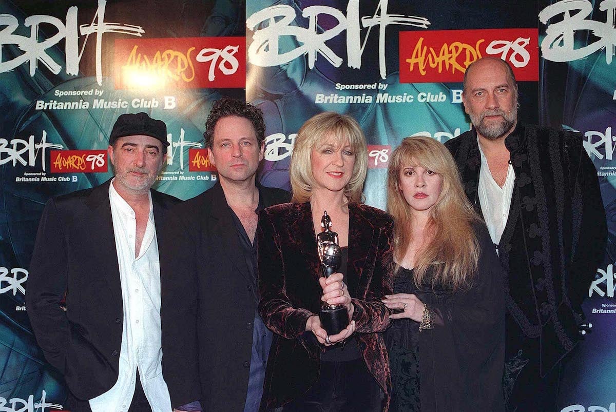 The members of Fleetwood Mac, who have been open about their cocaine abuse, pose together at an awards show holding a trophy.