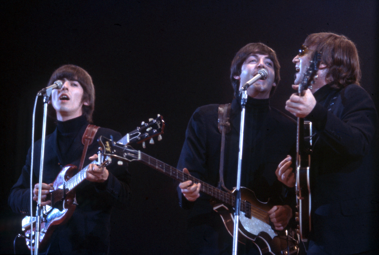 George Harrison and The Beatles performing in black in 1966.