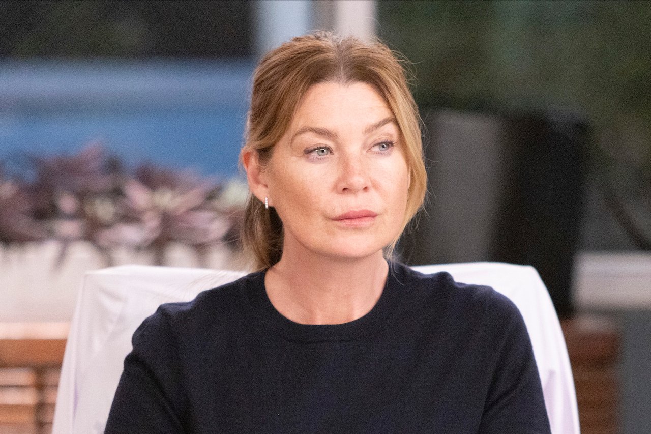 Ellen Pompeo as Meredith Grey looks serious while wearing a black sweater on 'Grey's Anatomy'.
