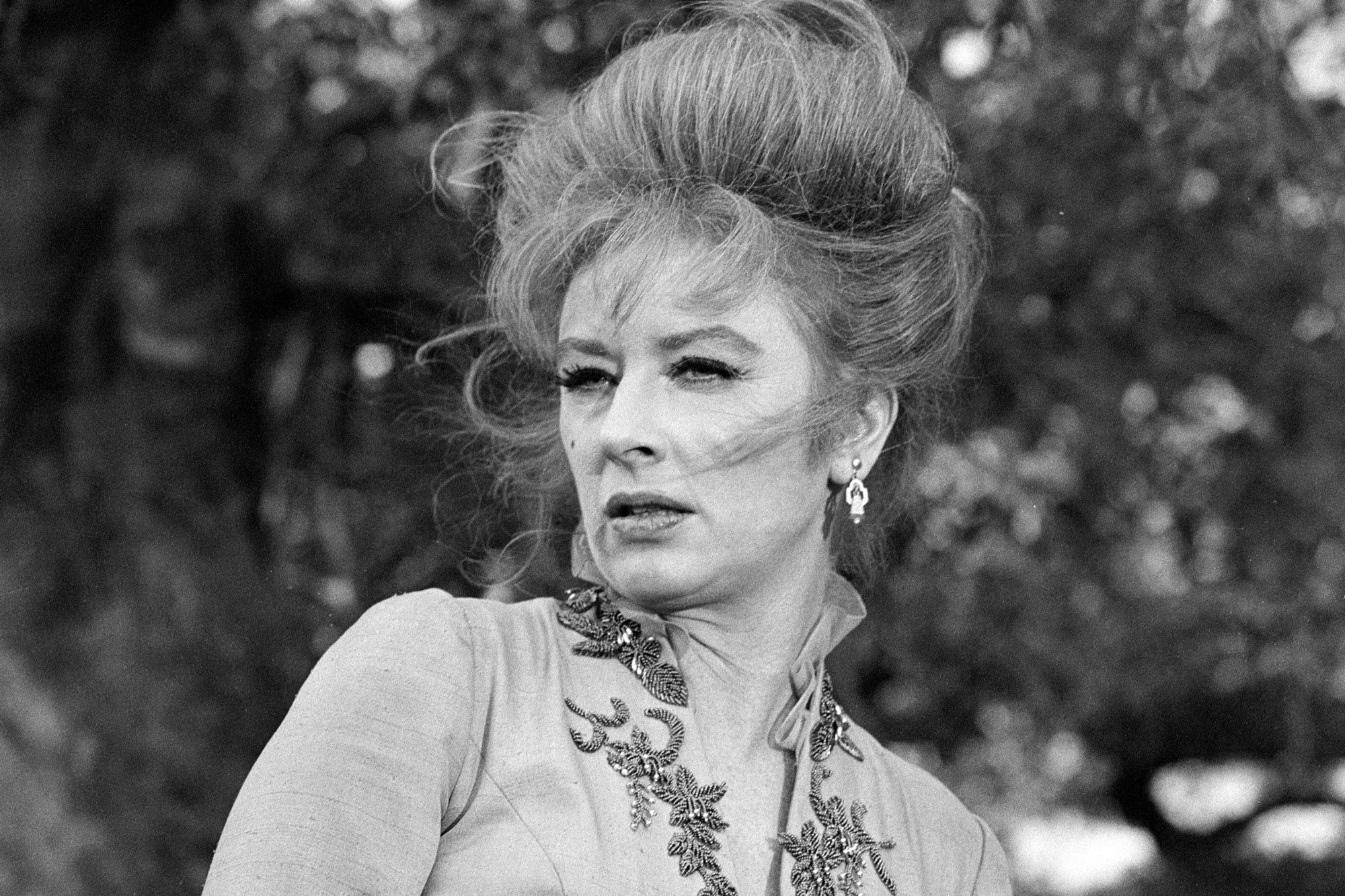 'Gunsmoke' Amanda Blake as Miss Kitty Russell in a black-and-white photograph looking off to the side with her hair blowing in the wind