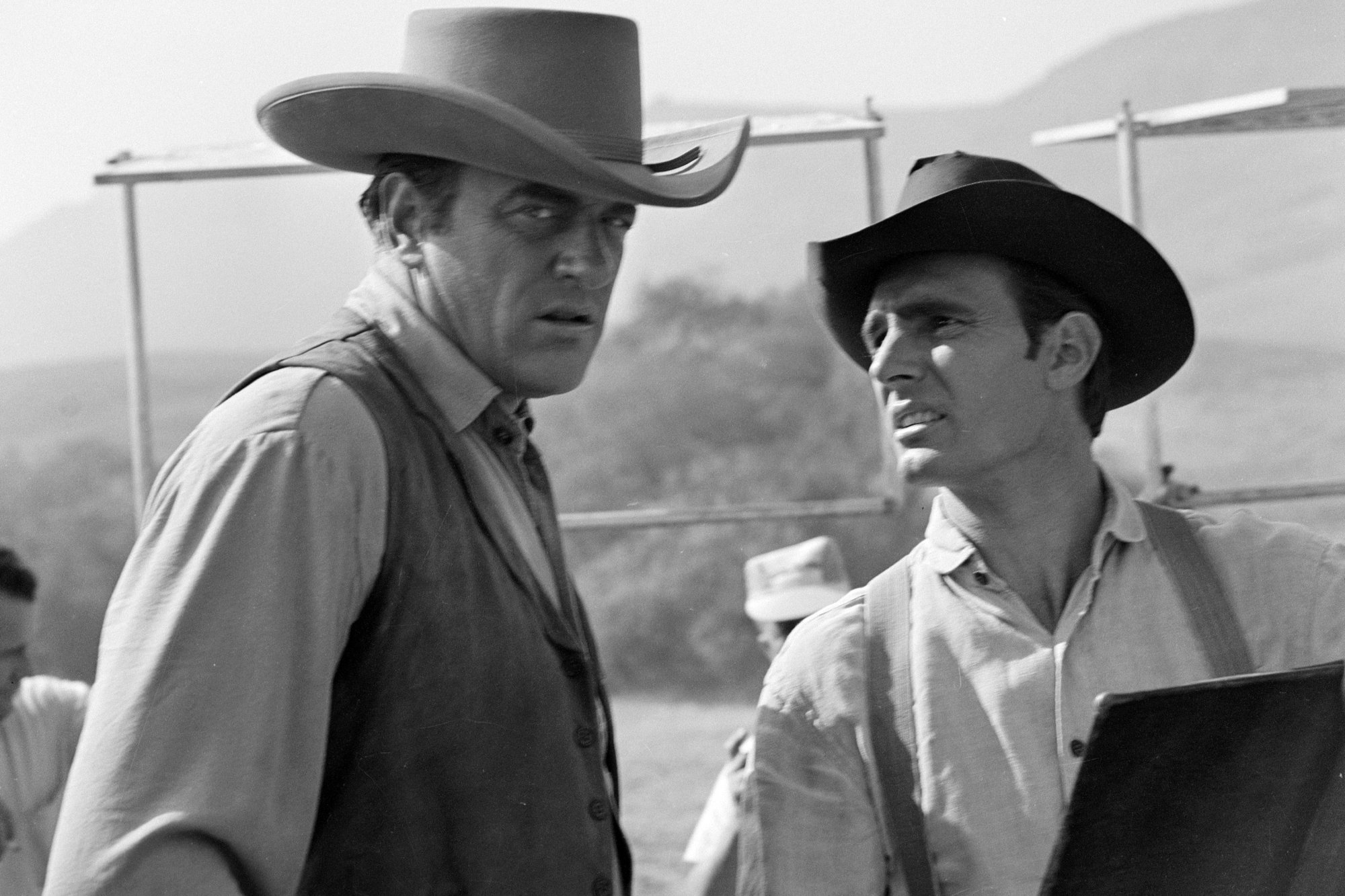 'Gunsmoke' James Arness as Marshal Matt Dillon and Dennis Weaver as Chester Goode. Weaveris looking up at Arness, who is giving a serious look to the camera.