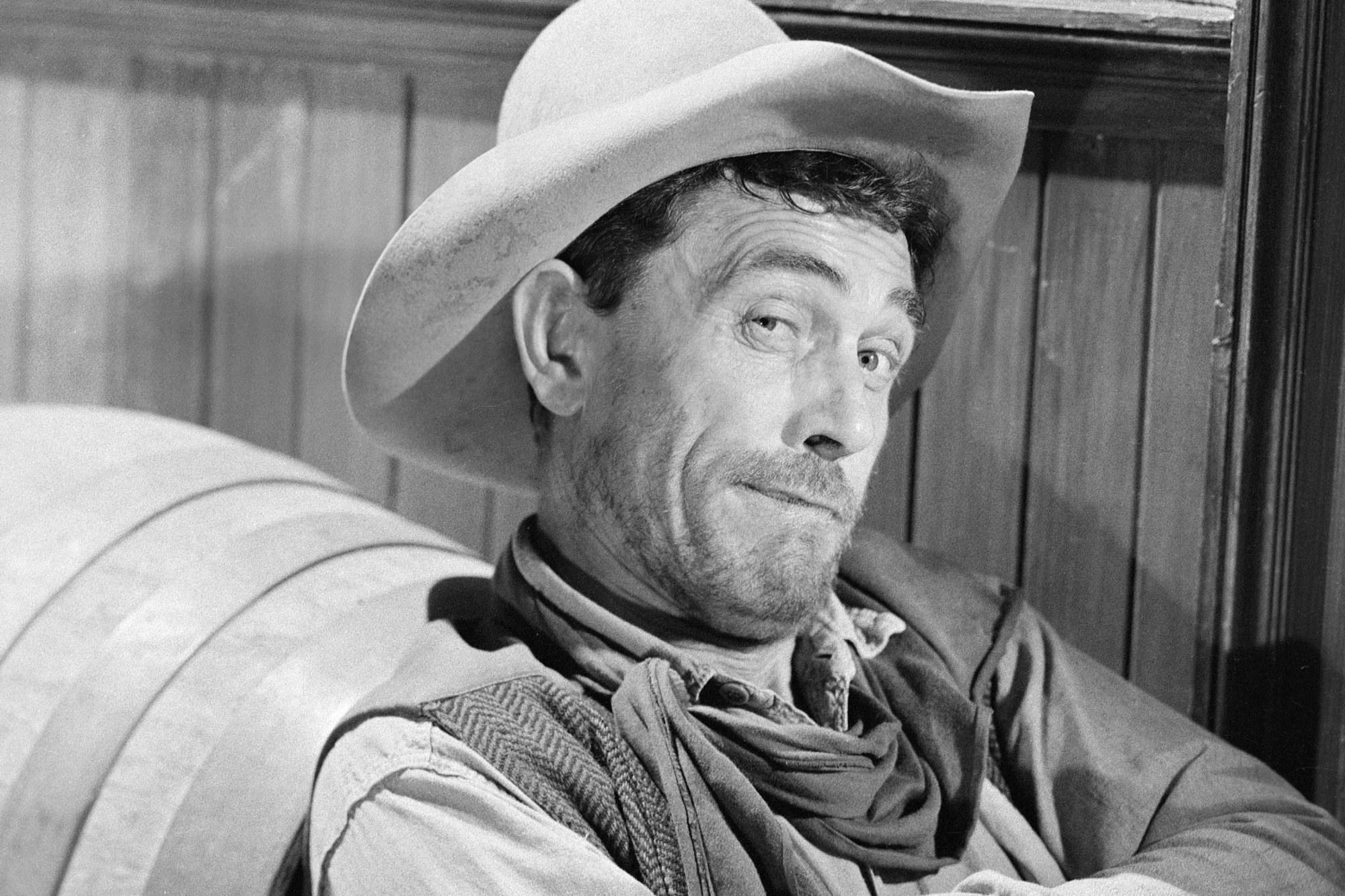 'Gunsmoke' Ken Curtis as Festus Haggen with a smirk on his face in a black-and-white picture. He's wearing a cowboy hat and Western clothing.