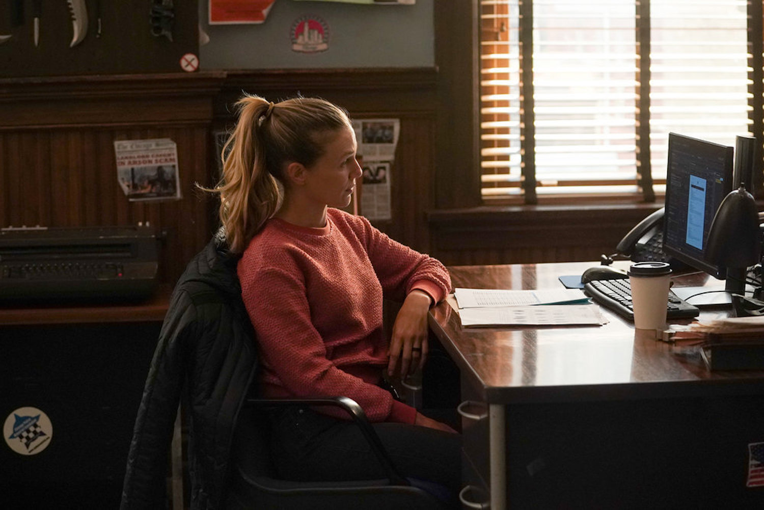 Hailey Upton sitting at a desk in front of a computer in 'Chicago P.D.' Season 10