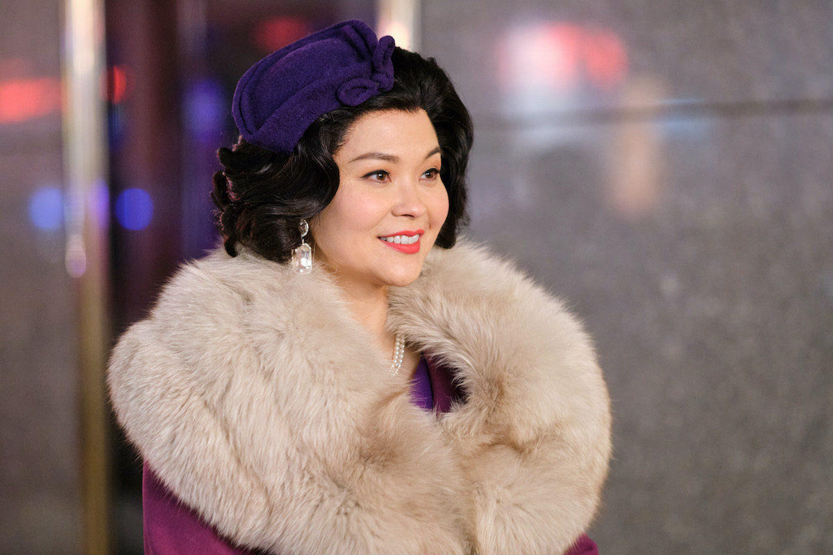 Woman wearing a coat with a large fur collar in the Hallmark Channel movie 'A Holiday Spectacular'