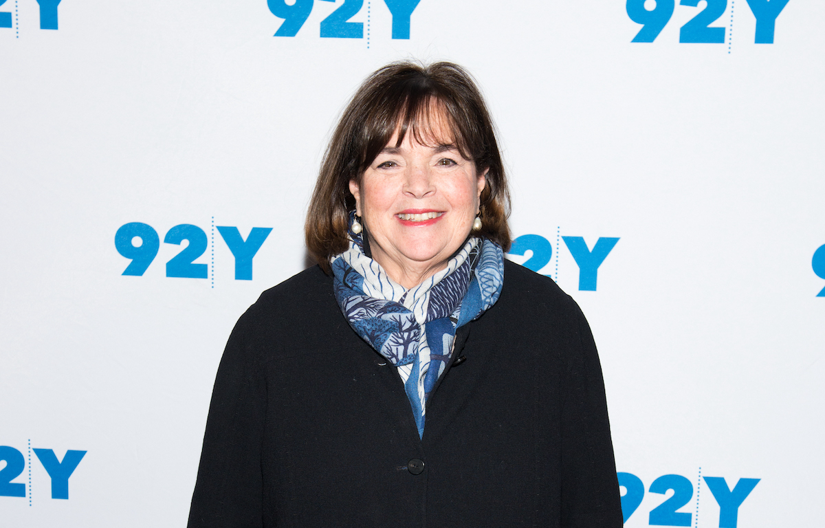 Ina Garten, who isn't cooking a 2022 Thanksgiving dinner, smiles wearing a black top and blue printed scarf at 'Ina Garten in Conversation with Danny Meyer'