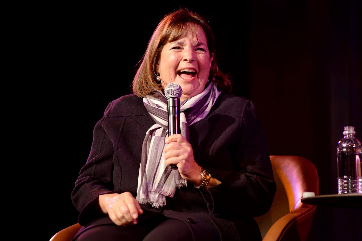 Ina Garten, whose brownie pudding is a go-to dessert, laughs holding a microphone