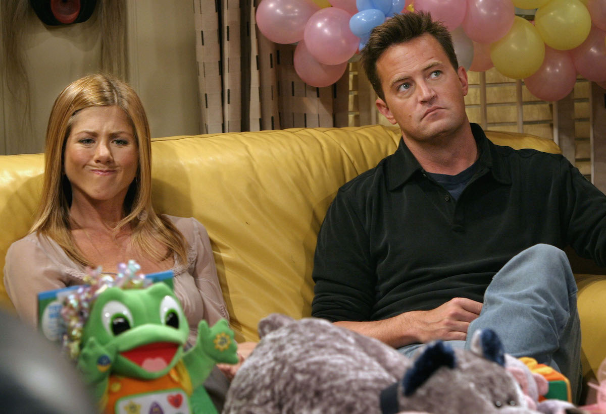 Jennifer Aniston makes a funny face as she sits with co-star Matthew Perry in between takes on the set of hit NBC series "Friends" in 2003