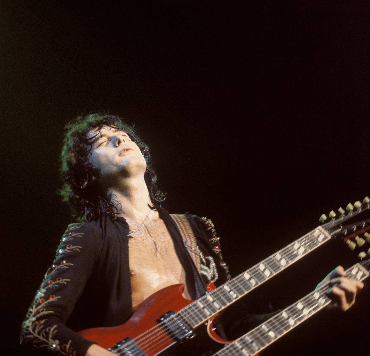 Jimmy Page plays guitar during a 1973 Led Zeppelin concert at Madison Square Garden, footage of which appeared in 'The Song Remains the Same' movie, along with Page's house.