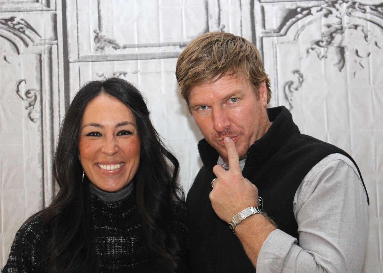 Joanna Gaines and Chip Gaines standing together and smiling