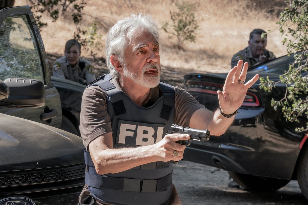 Joe Mantegna as David Rossi wearing an FBI vest and holding a gun in the 'Criminal Minds' revival 'Criminal Minds: Evolution' on Paramount+