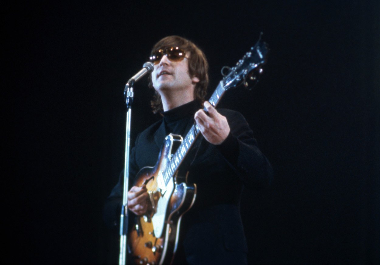 John Lennon performs during a May 1, 1966, concert, just before The Beatles released "Rain" and Lennon bragged about a studio trick he did before other bands.