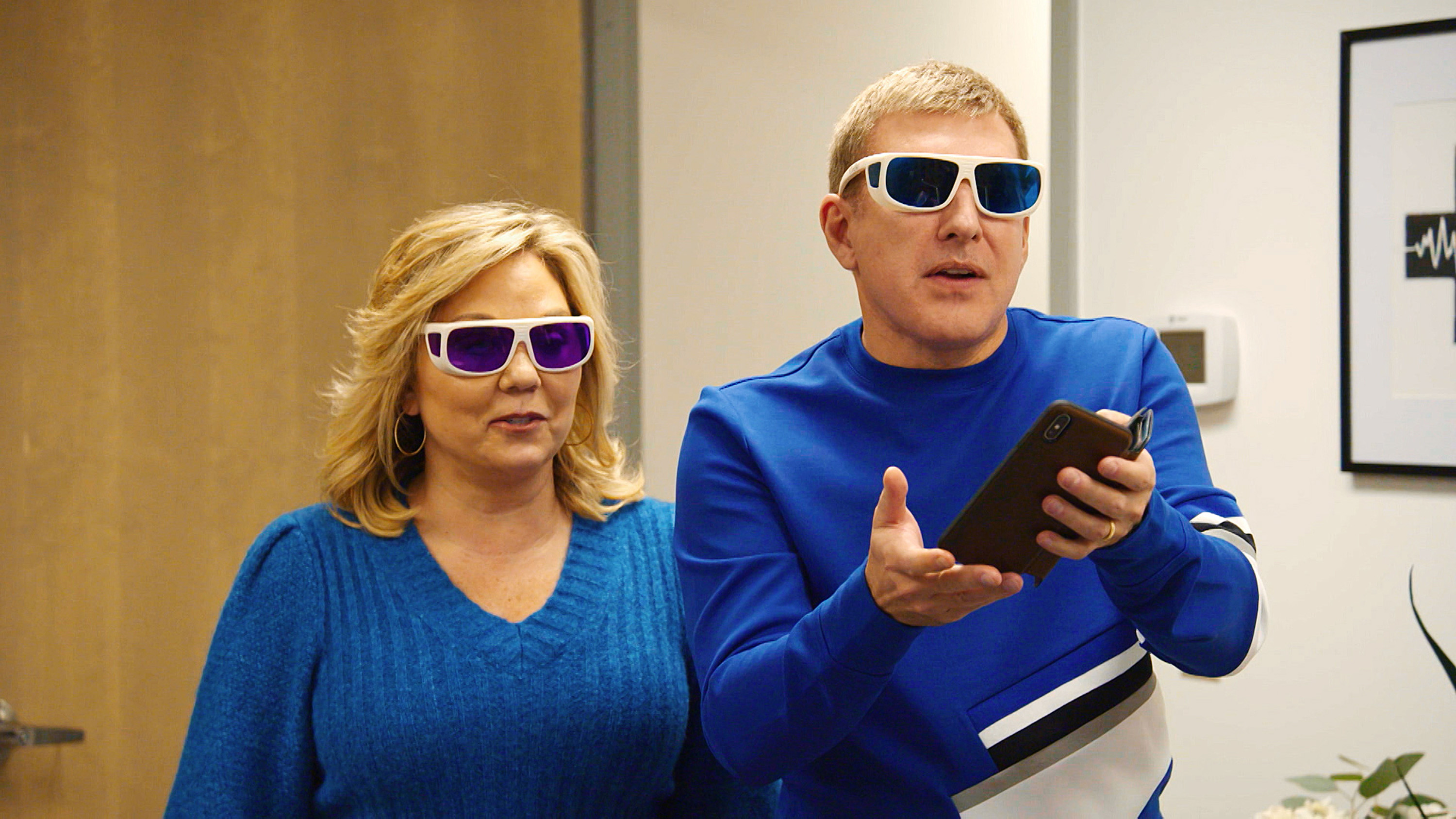 Julie and Todd Chrisley in blue tops and wearing sunglasses on 'Chrisley Knows Best'