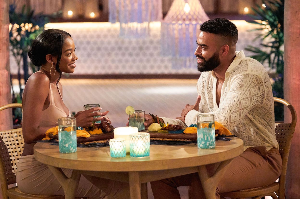 Eliza Isichei and Justin Glaze sitting across from each other in 'Bachelor in Paradise' Season 8