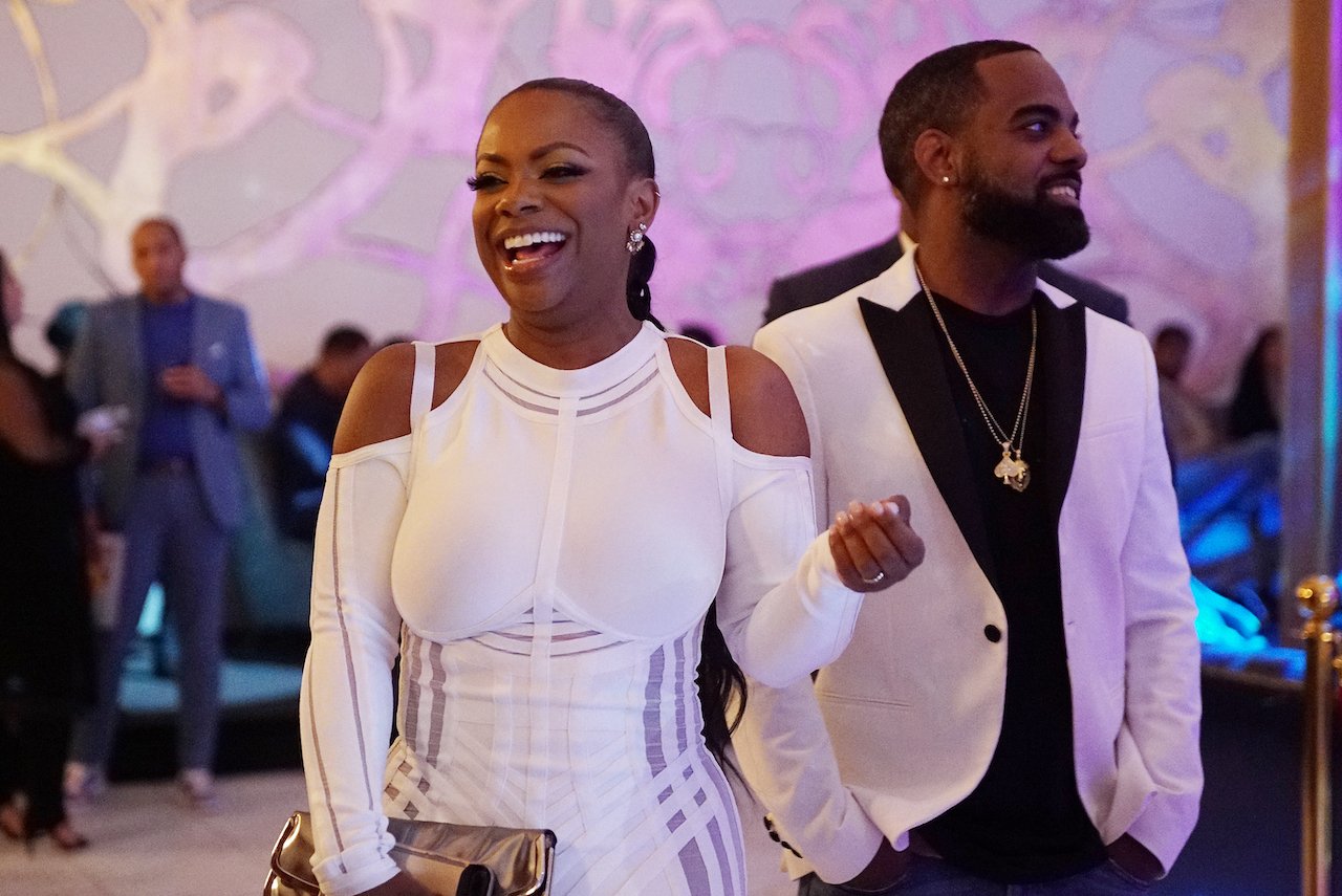 Kandi Burruss and Todd Tucker smile during 'RHOA' filming; Burruss and Tucker have been sued over a shooting