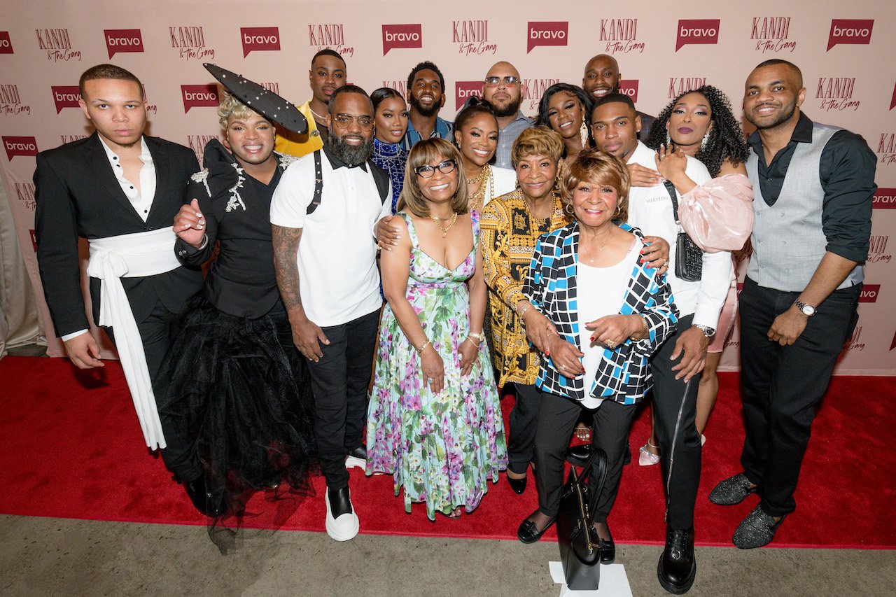 Kandi Burruss with 'Kandi & the Gang' cast on red carpet; Burruss confirmed the spinoff was cancelled